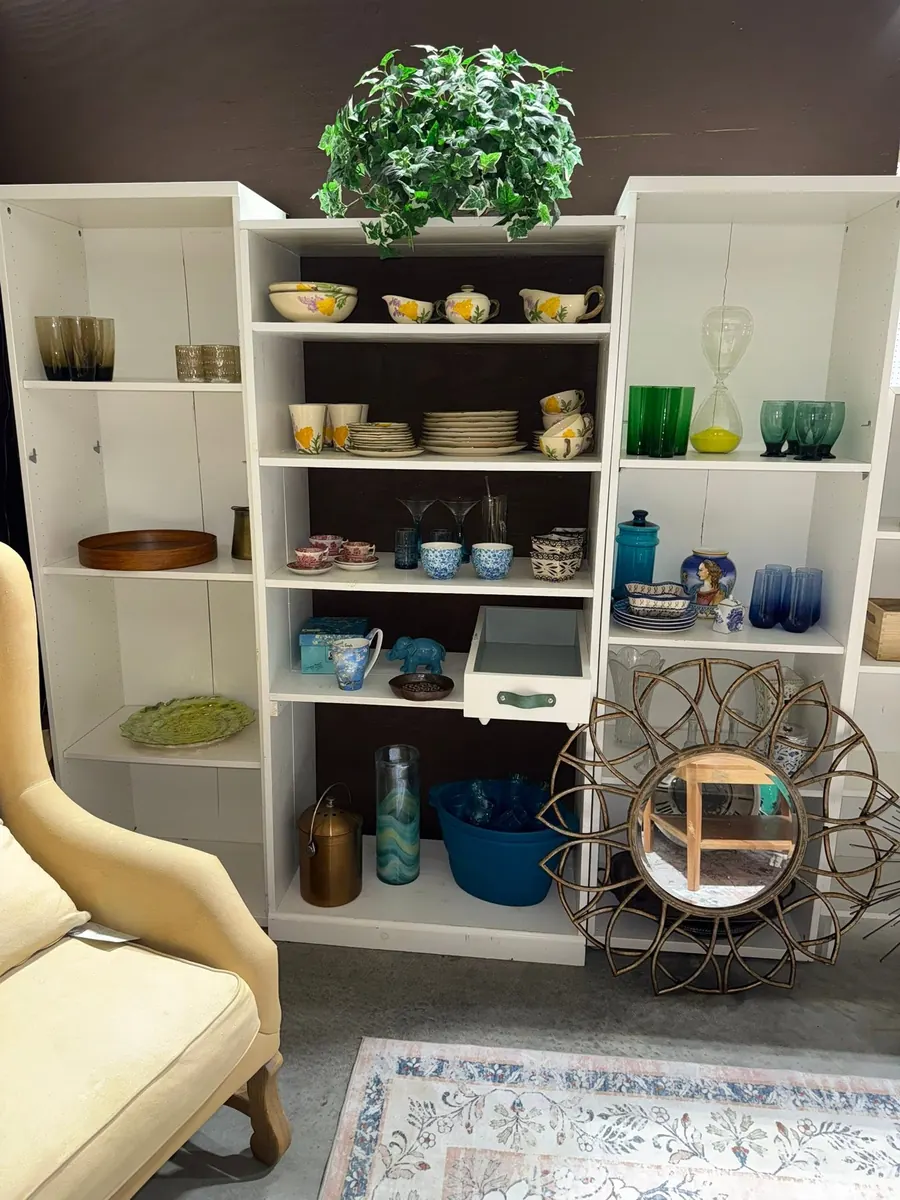 Dishes, glassware and vases displayed on white shelving