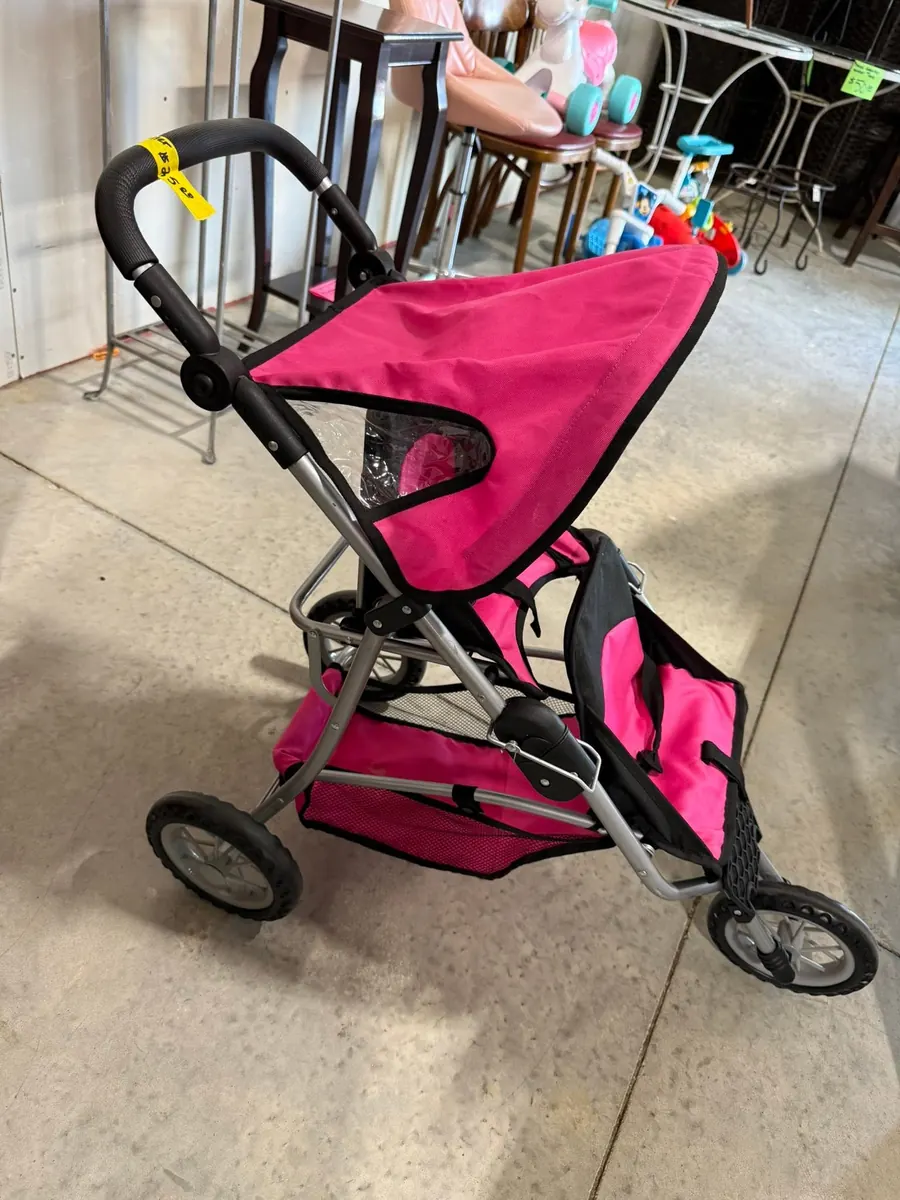Pink children's stroller available inside Thrift It Out